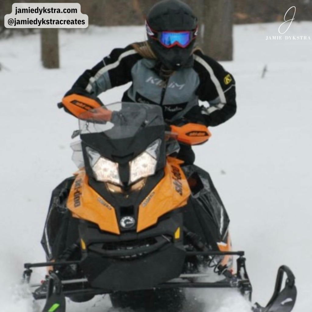 Jamie riding a snowmobile.