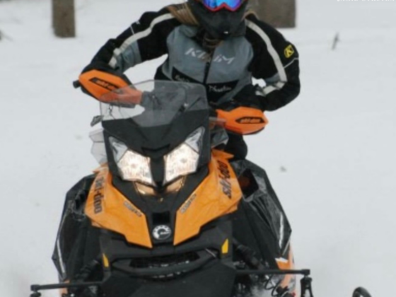 Jamie riding a snowmobile.