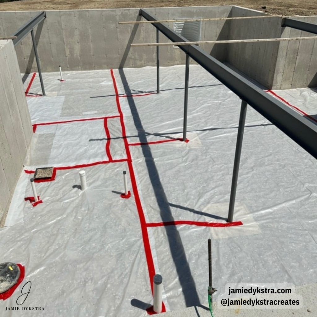 A picture of a concrete foundation for a house being built.
