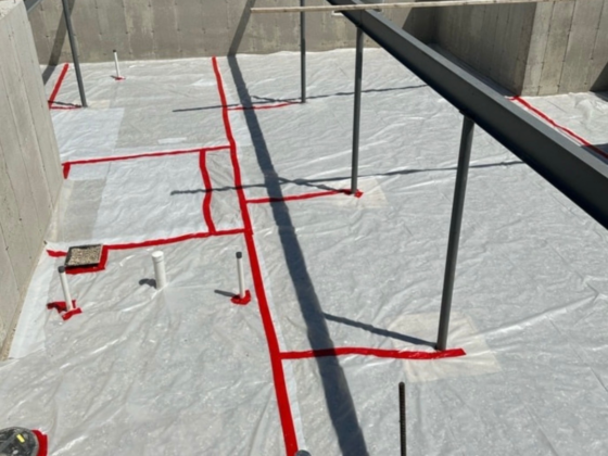 A picture of a concrete foundation for a house being built.
