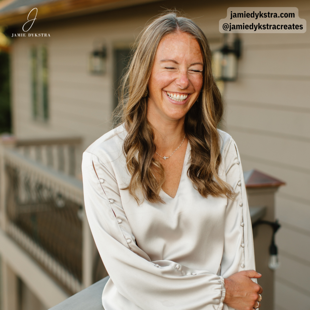 A picture of me leaning against a railing with one arm crossed, laughing.