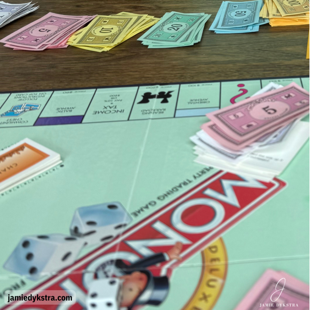 A picture of a monopoly board with monopoly money.