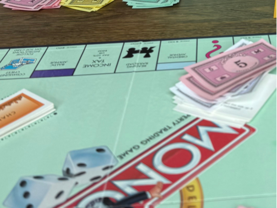 A picture of a monopoly board with monopoly money.