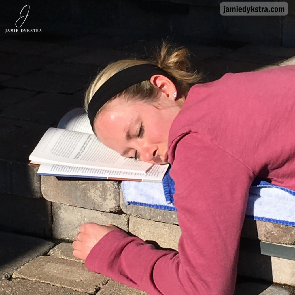 A picture of me asleep with my head on top of a book.