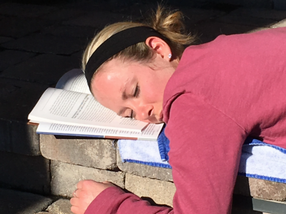 A picture of me asleep with my head on top of a book.