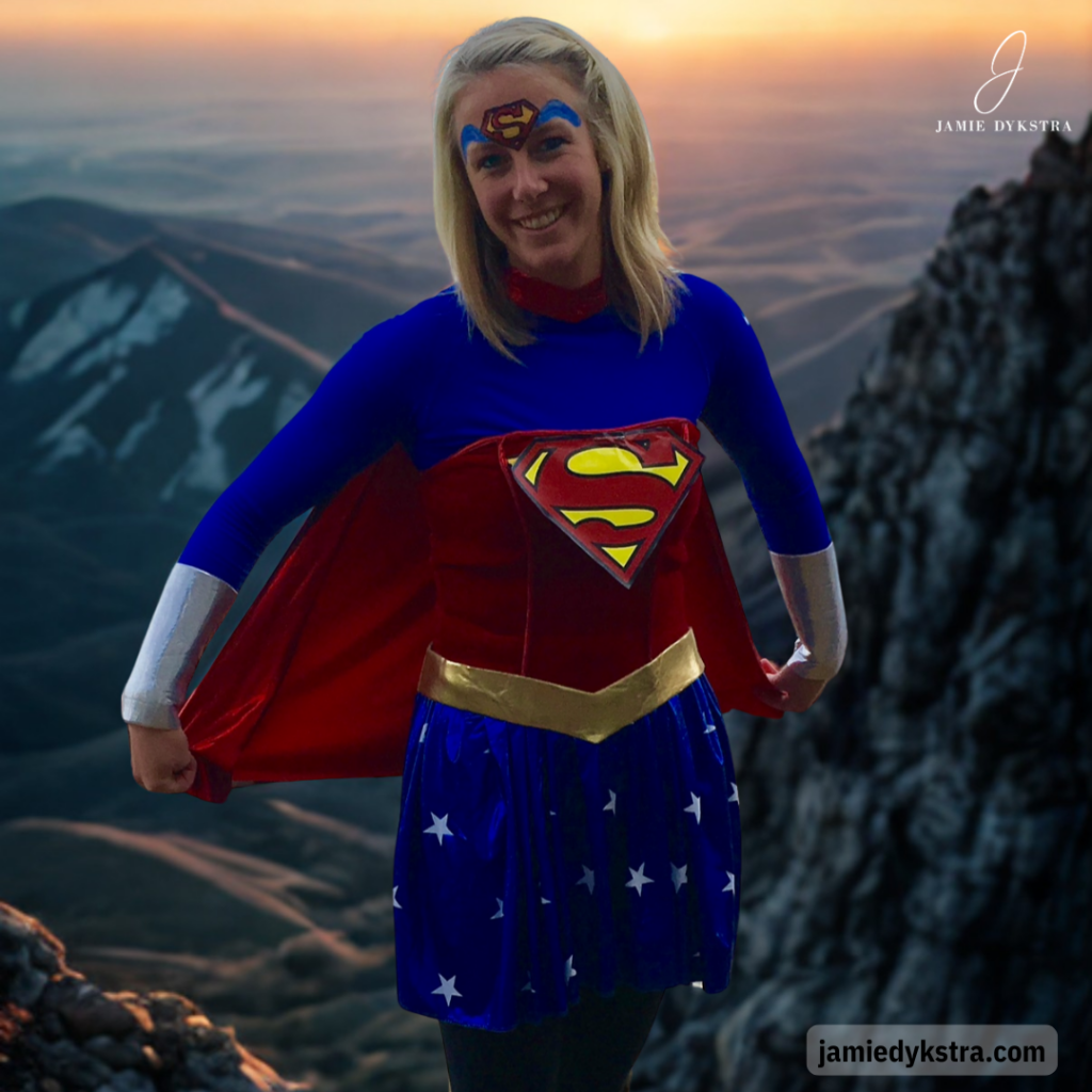 A picture of me in a superwoman costume with AI mountains in the background.