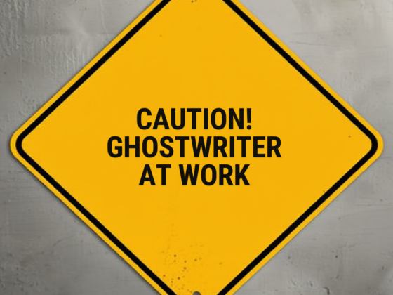 A sign in the shape of a yellow caution construction sign that says, "Caution! Ghostwriter at work"