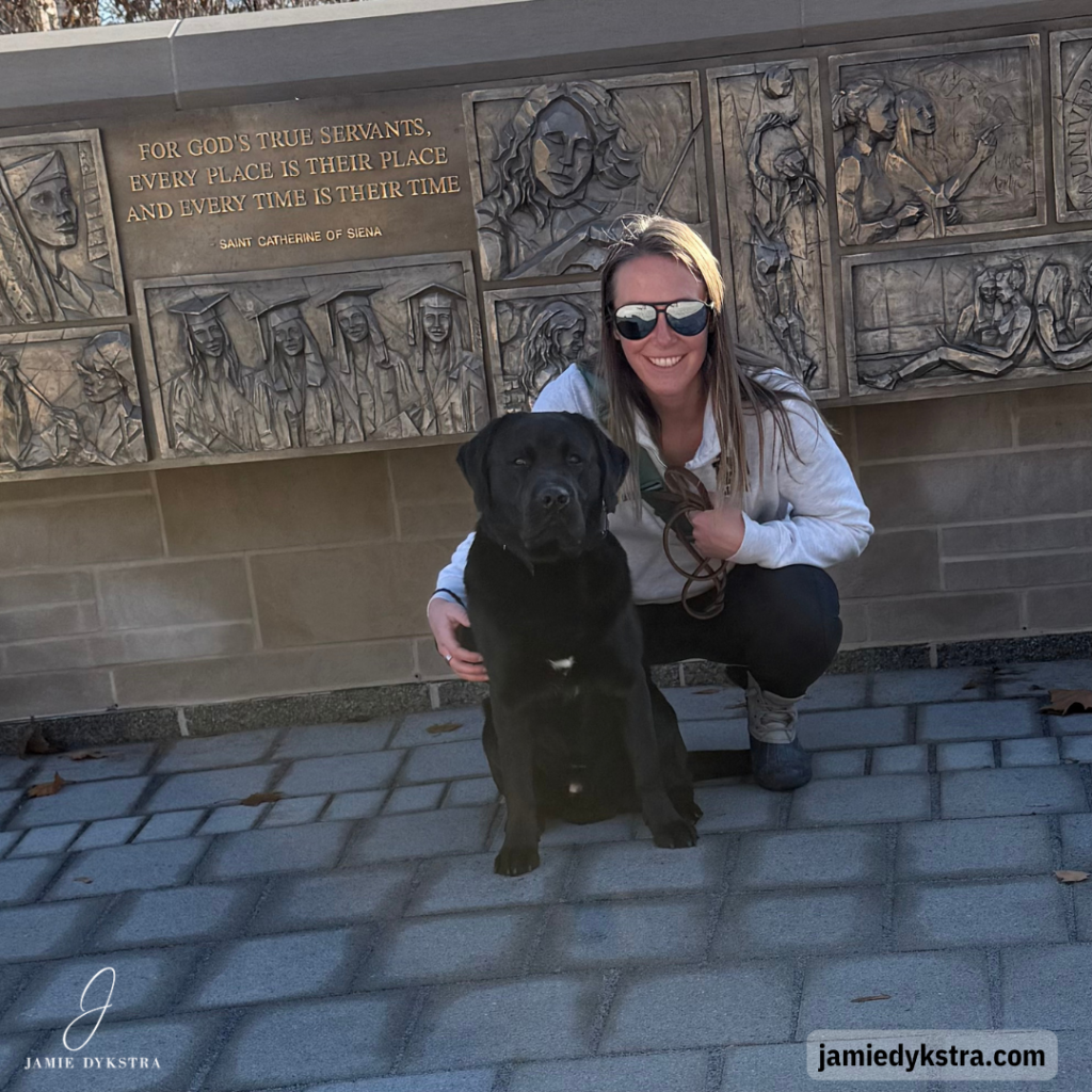 A photo of my black lab and I in the Notre Dame Circle monument.