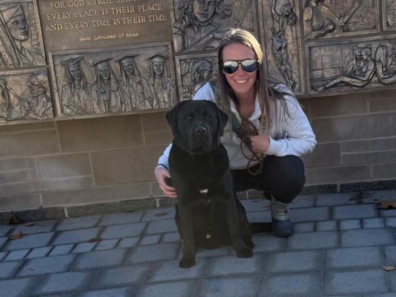 A photo of my black lab and I in the Notre Dame Circle monument.