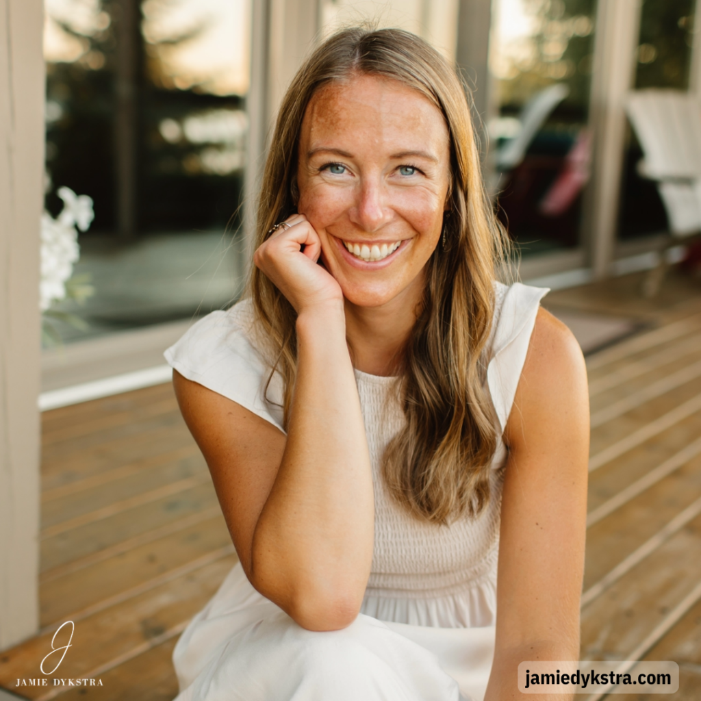 A photo of me sitting down on an outdoor deck with my chin resting on my hand.