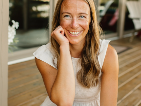 A photo of me sitting down on an outdoor deck with my chin resting on my hand.
