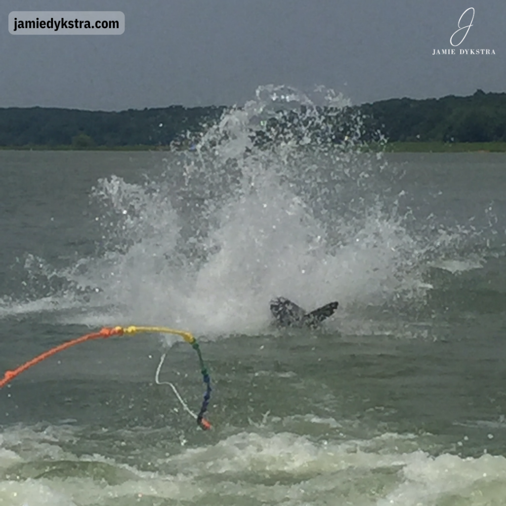 A picture of me falling while water skiing where all you can see is the tips of the skis, splashing water, and the rope.