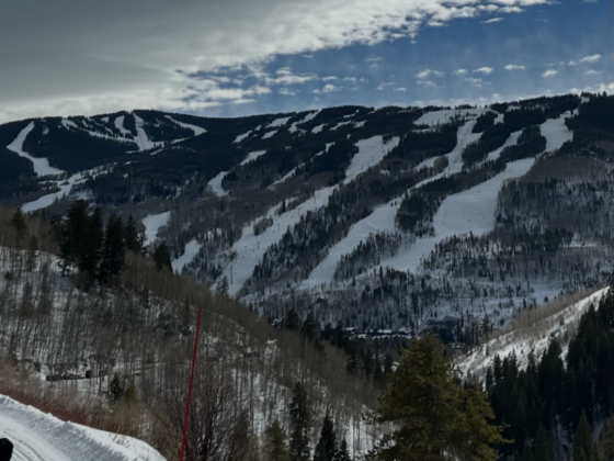 A photo from a mountain of ski runs on another mountain.