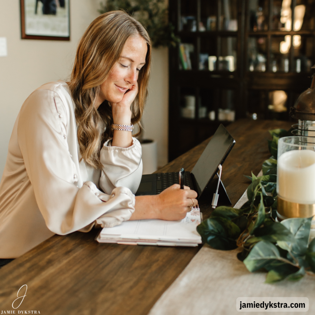 A photo of me writing in a notebook sitting at a table.
