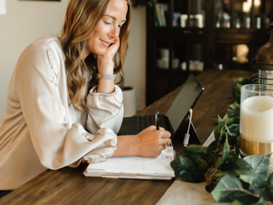 A photo of me writing in a notebook sitting at a table.