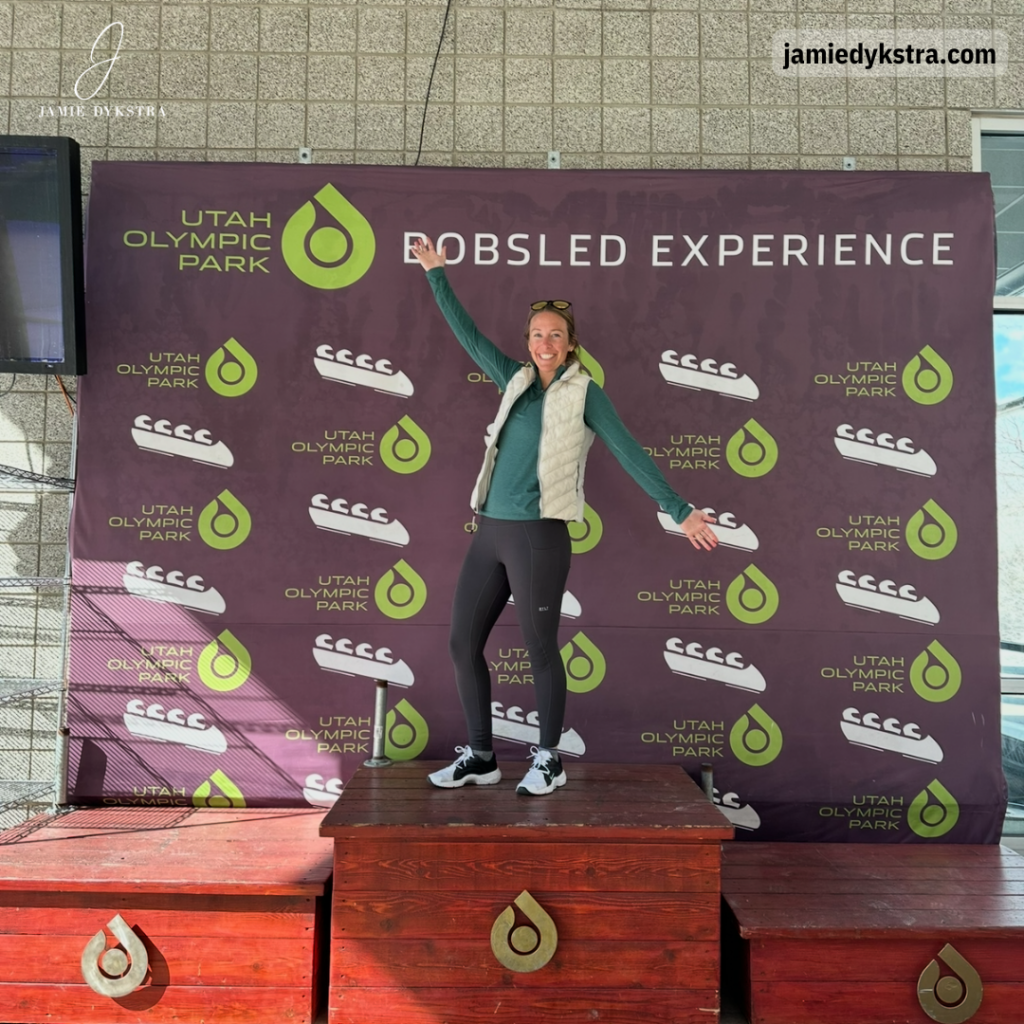 A photo of me standing on a bobsled podium at the Olympic park in Park City, UT.