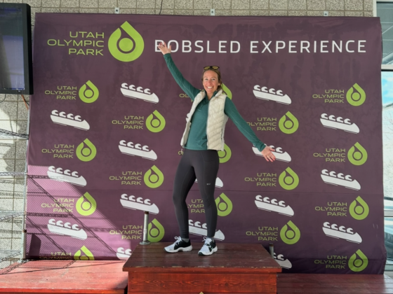 A photo of me standing on a bobsled podium at the Olympic park in Park City, UT.