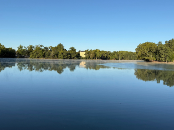 A picture of a small, calm lake.